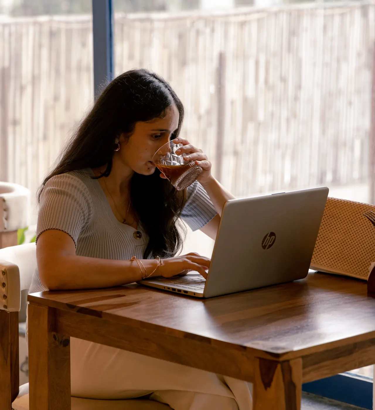 A guest working with a coffee by the window